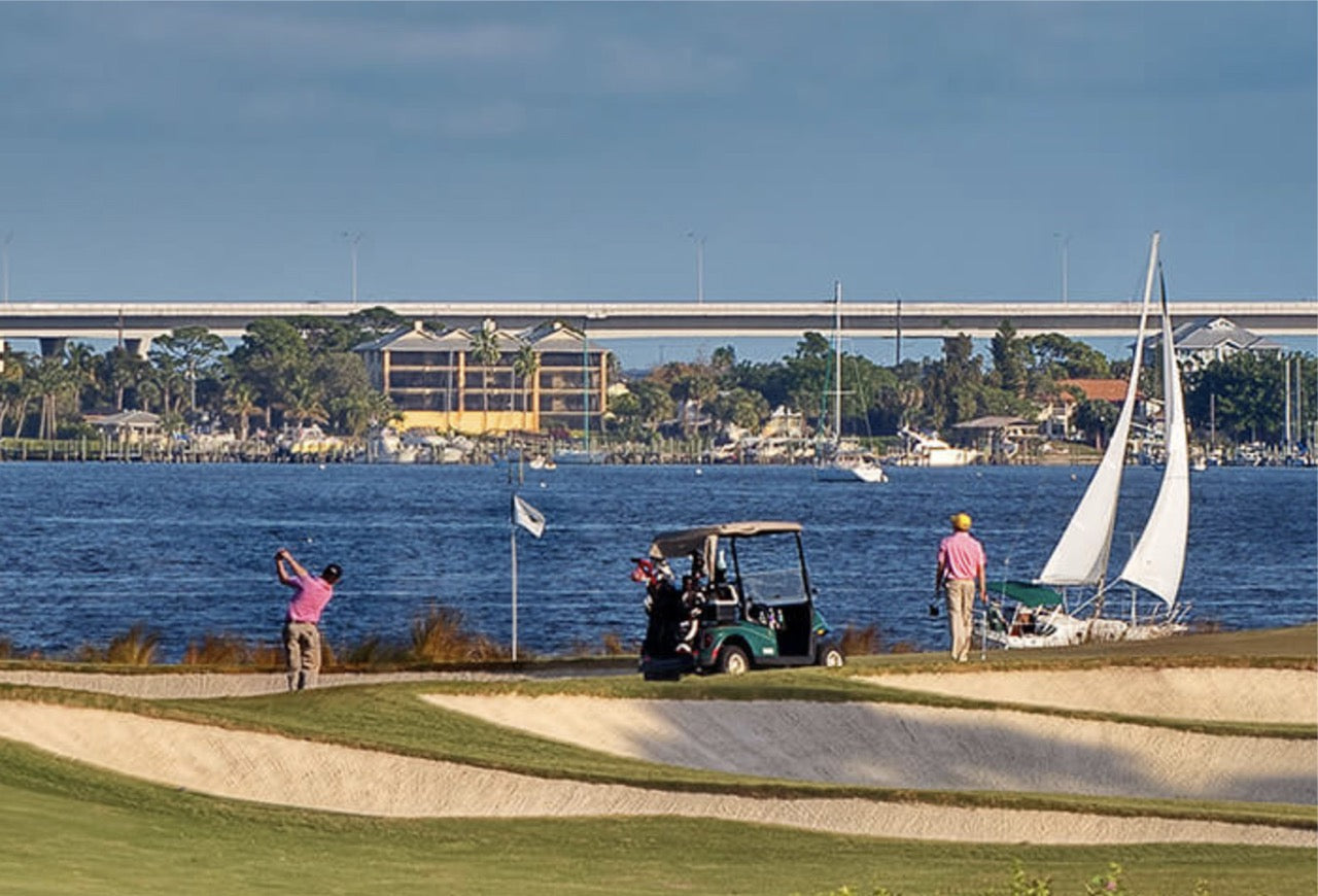 Golfers playing at the Floridian National Golf Club, a premier destination for shipping golf clubs and golf travel with BagCaddie.